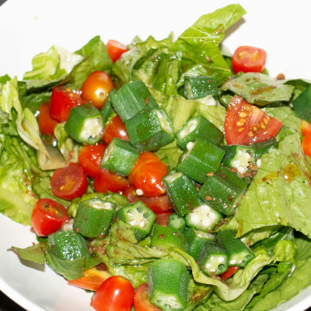 Delicious healthy salad with okra, tomatoes, and lettuce perfect for a fresh meal.